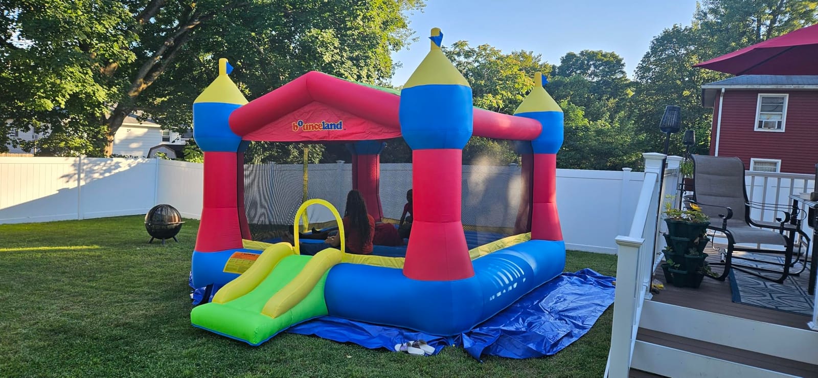 Bounceland Inflatable Party Castle Bounce House Bouncer, 16 ft L x 13 ft W x 10.3 ft H, Basketball Hoop, Removable Sun Roof, UL Strong Blower included, Fun Slide and Bounce Area, Castle Theme for Kids customer photo 1