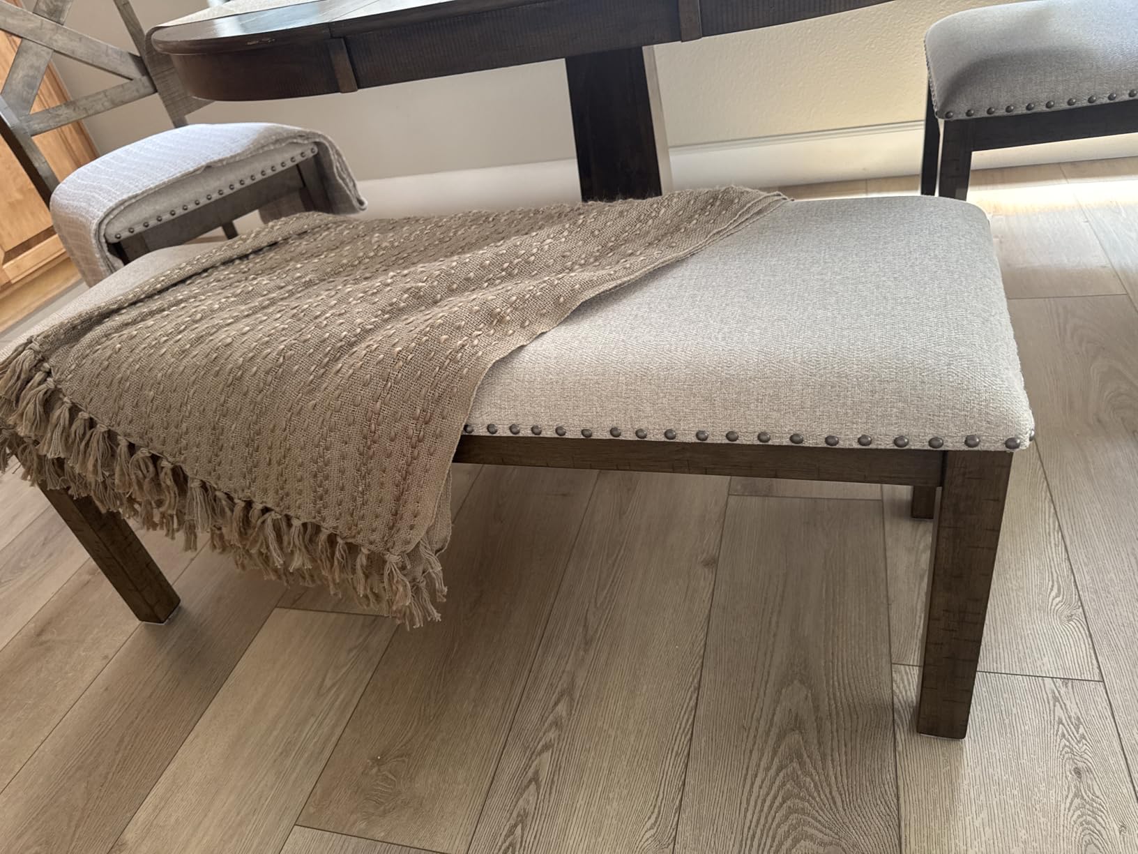 Signature Design by Ashley Moriville Wood Upholstered Dining Bench, Beige | Cushioned 48-inch dining seat in textured beige polyester, Rustic distressed nutmeg wood frame with bronze nailhead trim customer photo 2