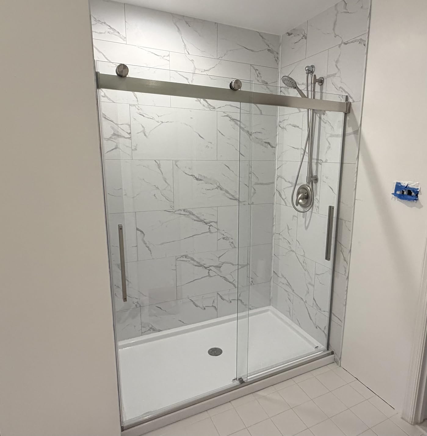 Palisade 25.6 in. x 14.8 in. Vinyl Wall Tiles in Carrara Marble (8 Pack) | Interlocking waterproof tiles for kitchen or bathroom customer photo 1