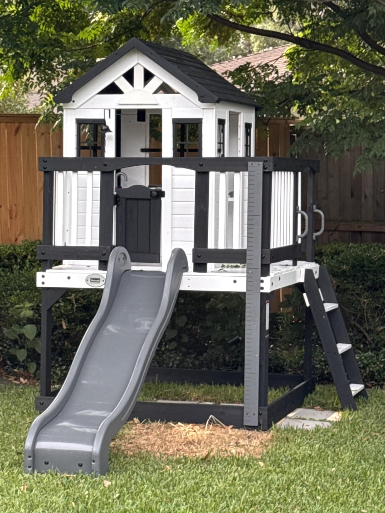 Backyard Discovery Echo Heights Elevated Cedar Wooden Kids Playhouse with Wave Slide, Play Kitchen, Wrap-Around Deck, Flat-Step Ladder, Half Door, Windows, Bell, and Growth Chart for Outdoor Play customer photo 1