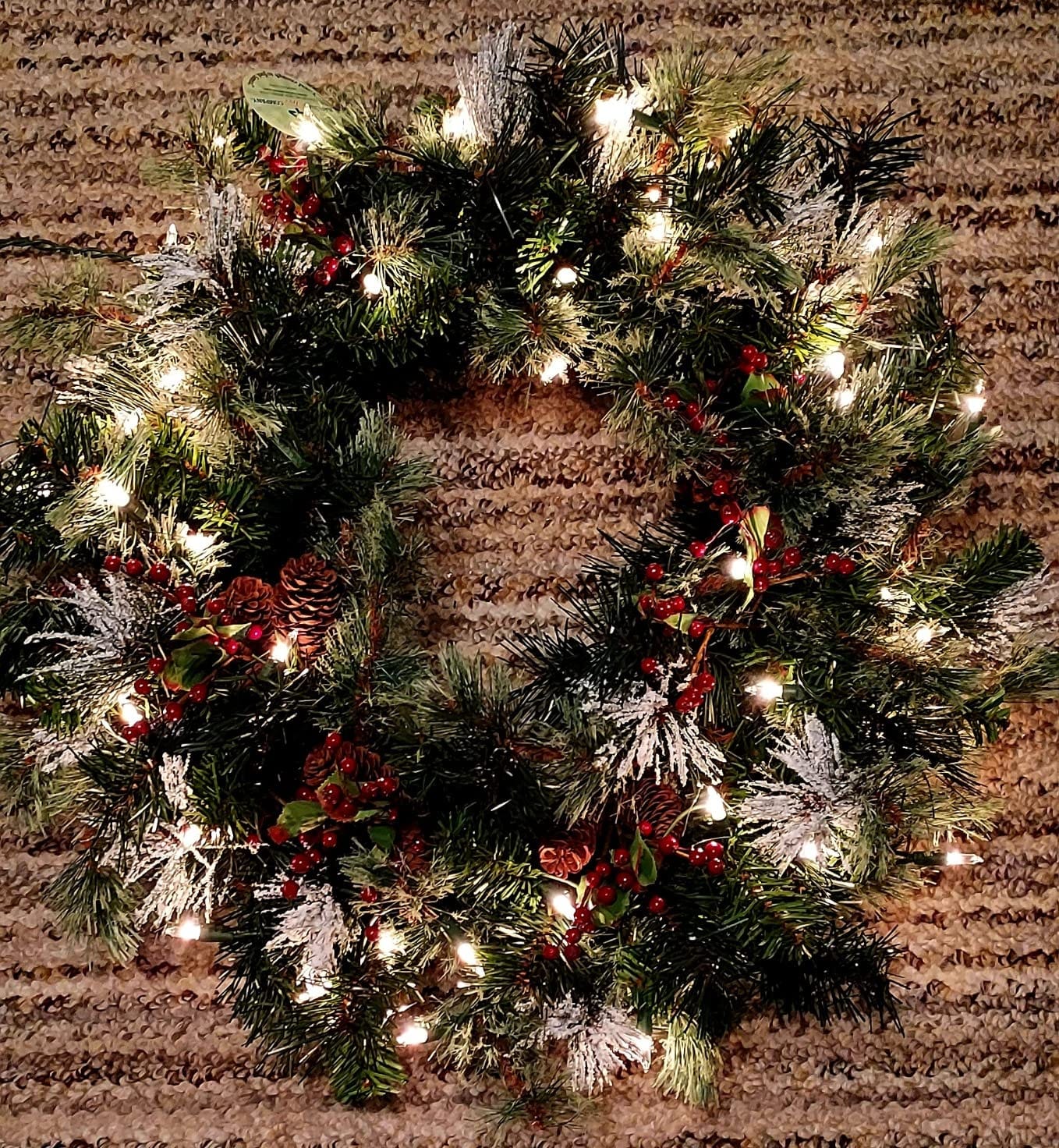 National Tree Company 24in Pre-Lit Wintry Pine Artificial Christmas Wreath | 50 Clear Lights, 113 Tips, Christmas Decoration with Pinecones, Red Berries, Snowy Bristle, Green customer photo 1